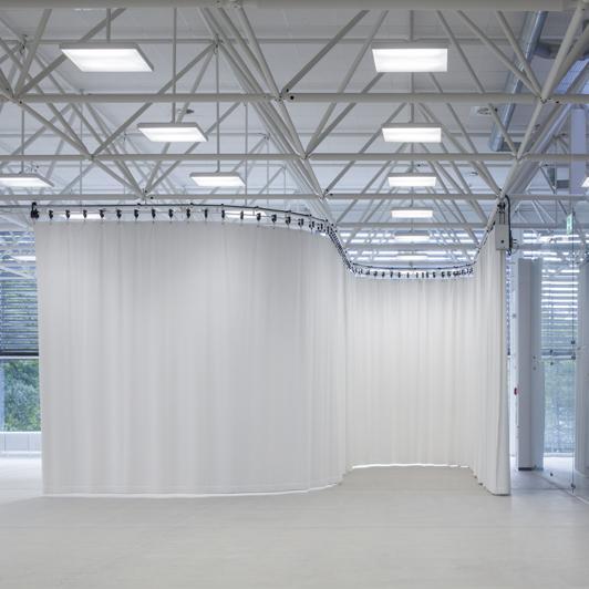 White curtain on curved rail in foyer