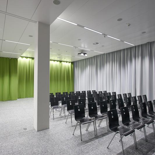 Seating rows with acoustic curtains