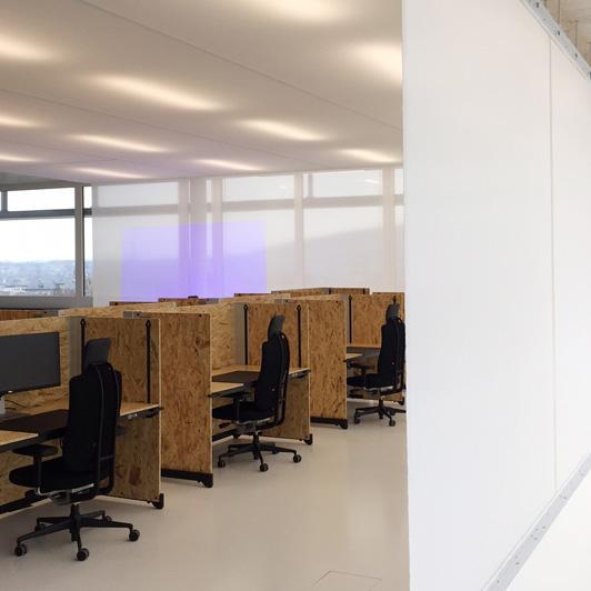 Individually separated workstations with translucent acoustic curtain in the background